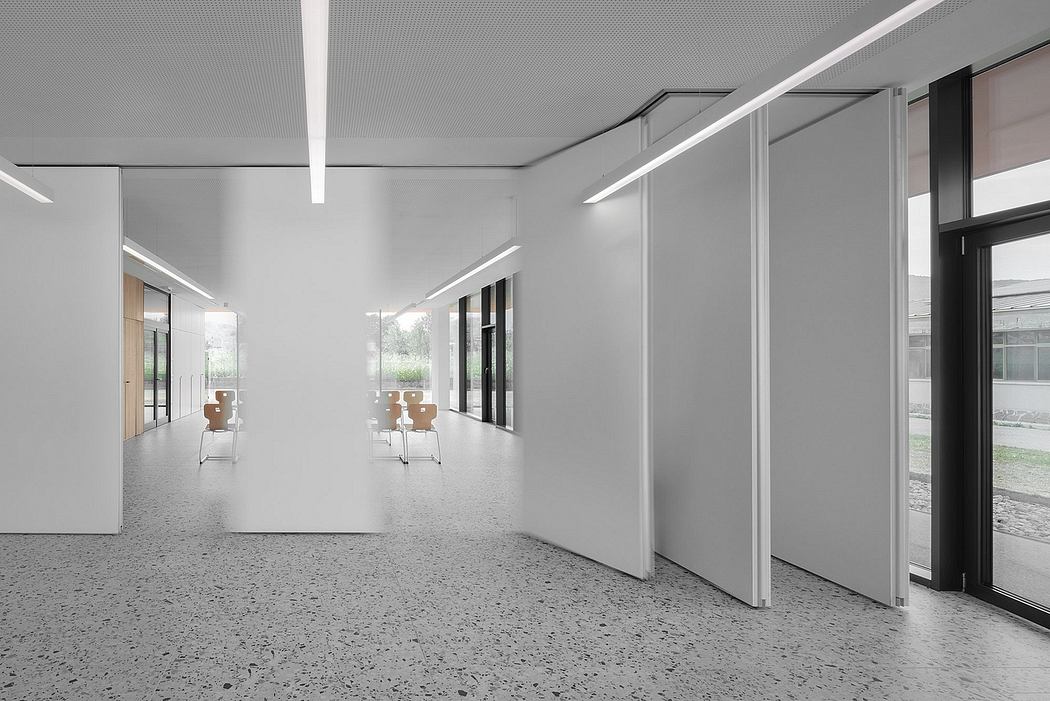 Modern minimalist interior with clean lines, recessed lighting, and terrazzo flooring.