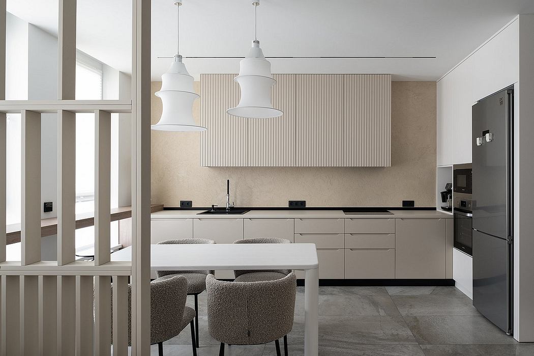 Minimalist, light-filled kitchen with sleek cabinetry, modern pendants, and seamless integration.