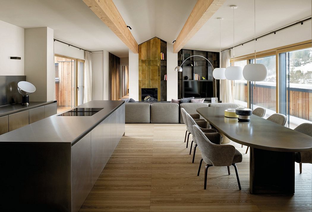 Modern, open-plan kitchen, dining, and living area with wooden beams, gray furniture, and sleek cabinetry.