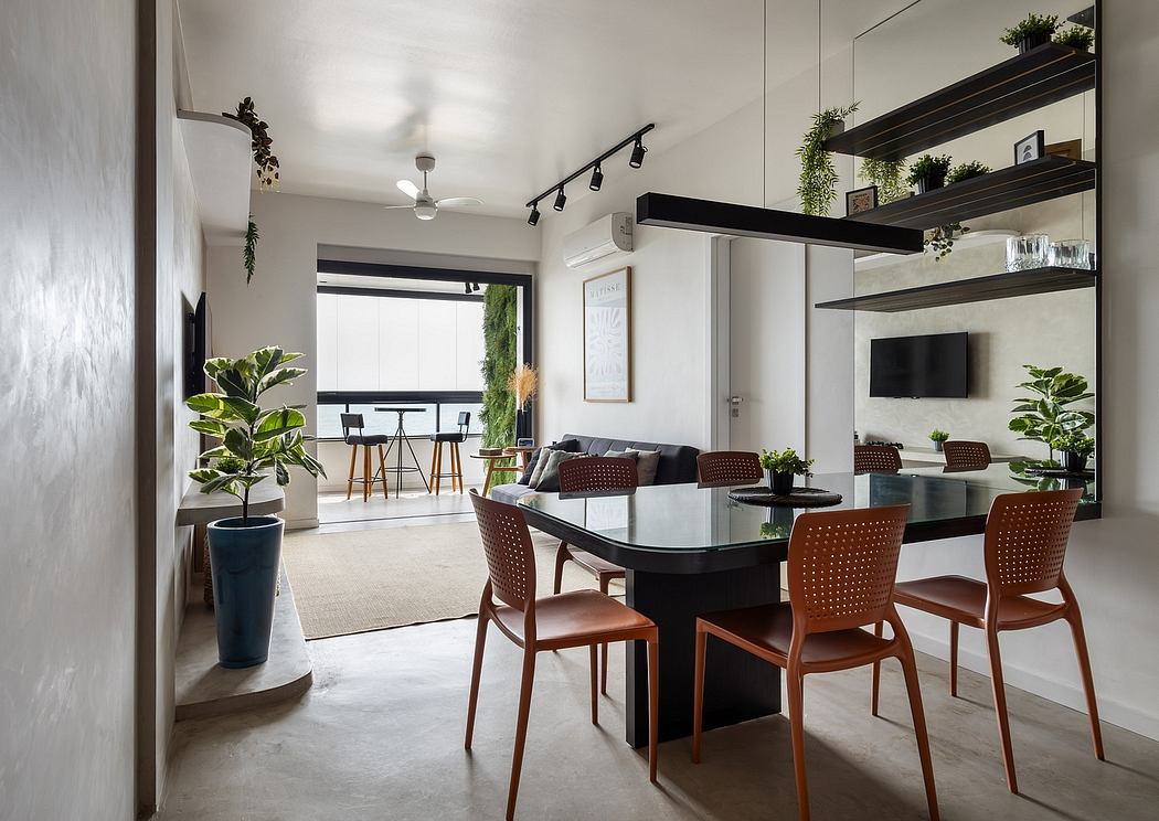 Minimalist open-plan living area with dark wood furnishings, potted plants, and modern lighting.
