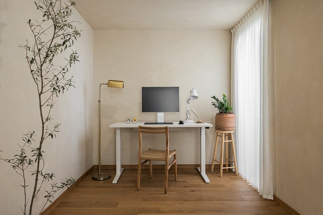 Light-filled home office with minimalist desk, wooden chair, and plant decor.