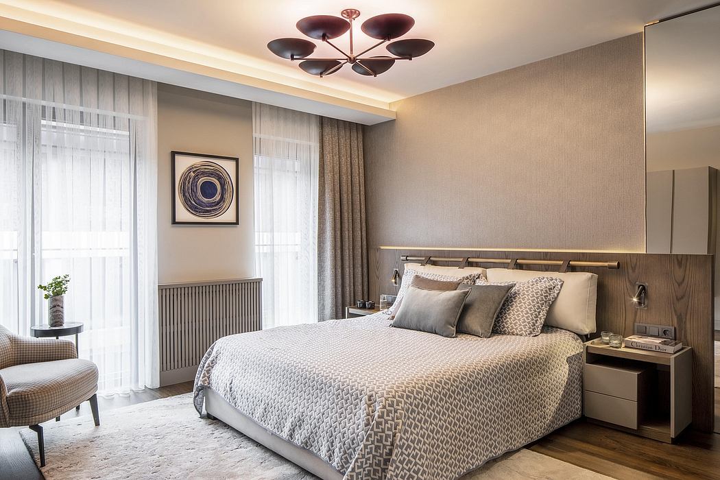 Elegant master bedroom with modern chandelier, textured walls, and plush bedding.