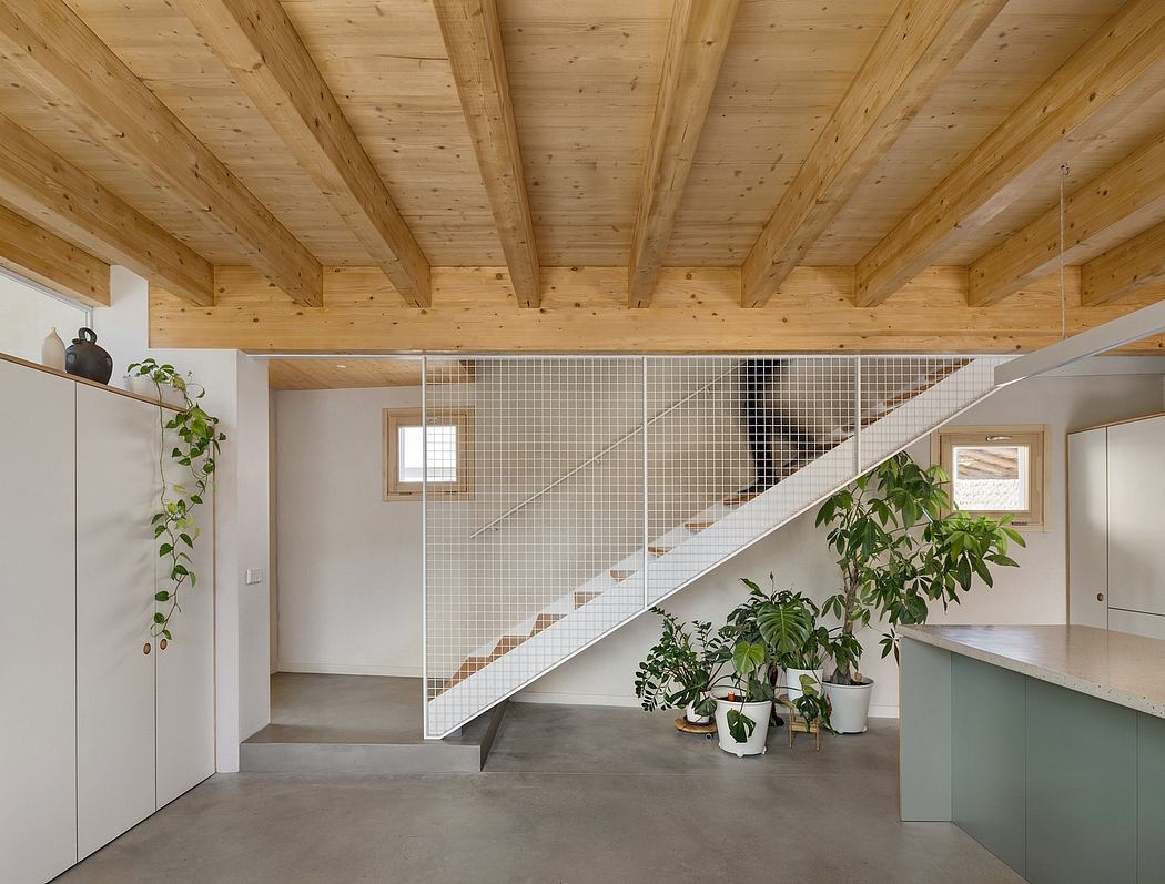 Wood-beamed ceiling, minimal staircase, and potted plants in a modern, open interior.