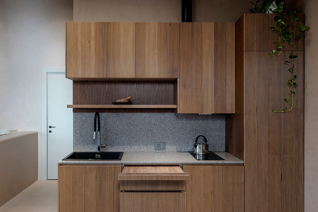 Sleek modern kitchen with wooden paneled cabinetry, granite countertops, and integrated appliances.