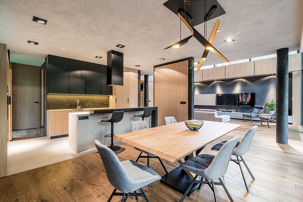 Sleek, modern kitchen with clean lines, wood accents, and a statement light fixture.