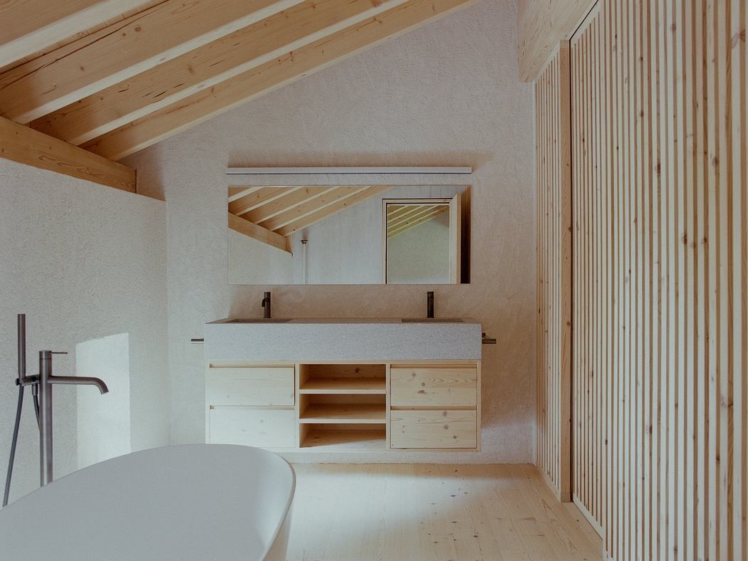 A minimalist bathroom with wooden beams, a vanity, and a standalone bathtub.