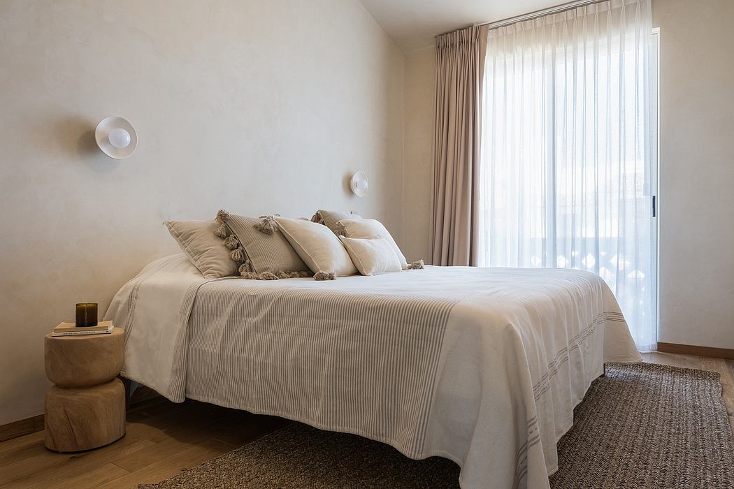 Peaceful bedroom with neutral tones, textured bedding, and minimalist decor elements.