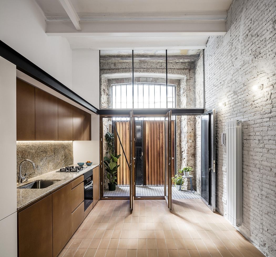 Rustic exposed brick walls, sleek wood cabinetry, and a modern glass-enclosed entryway.