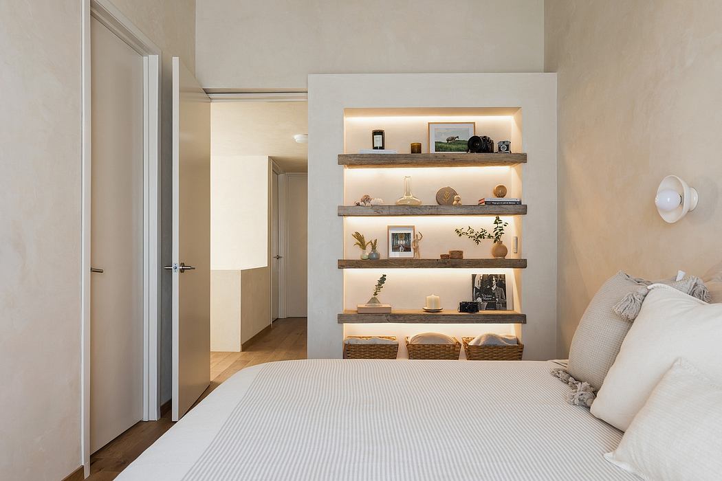 A cozy bedroom with minimalist shelving, warm lighting, and textured accents.