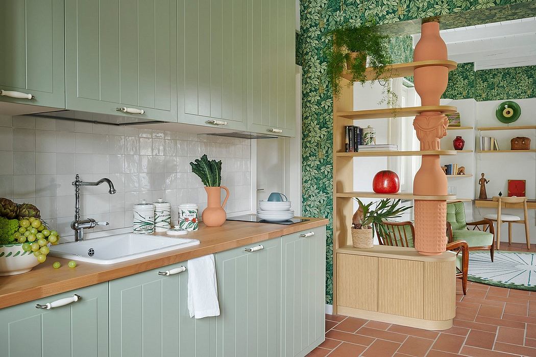 Cozy retro-style kitchen with mint green cabinetry, floral wallpaper, and wooden accents.