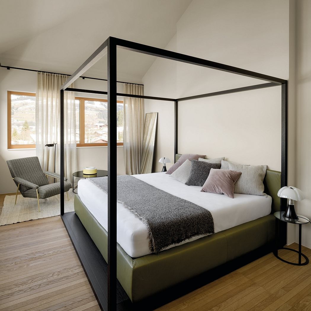 Sleek modern bedroom with black metal canopy bed, minimalist decor, and large windows.