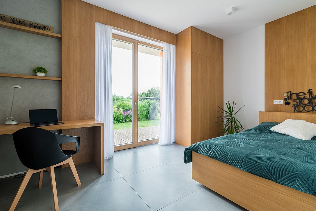 Spacious bedroom with modern wooden wall panels, large window, and minimalist decor.