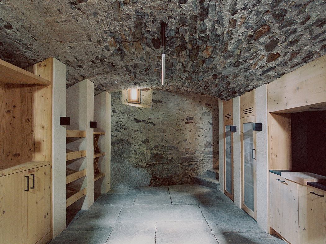 A rustic, cave-like interior with wooden shelves, cabinets, and a natural stone ceiling.