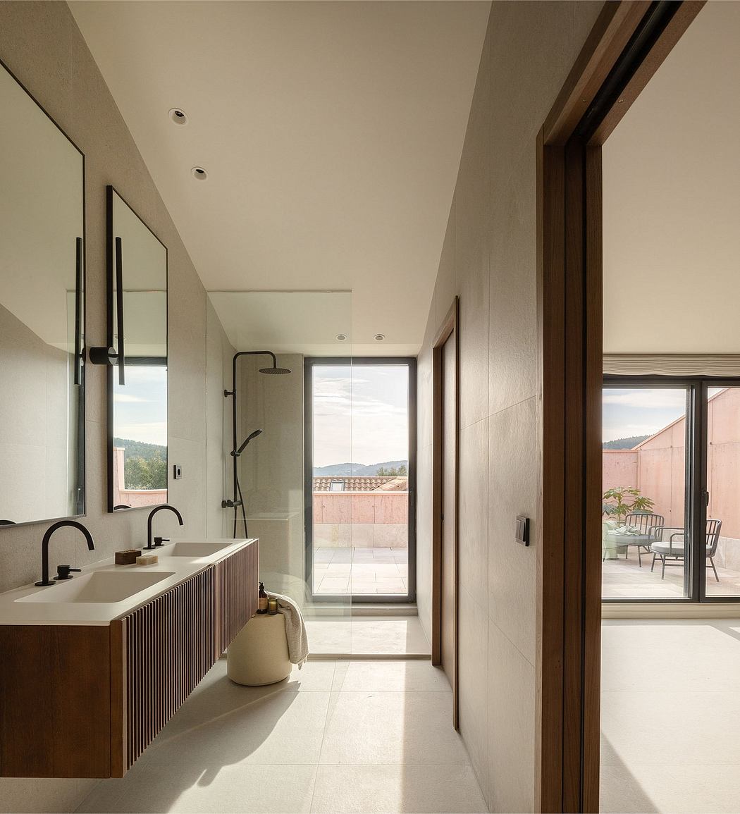 Minimalist bathroom with wooden vanity, large window, and access to outdoor terrace.