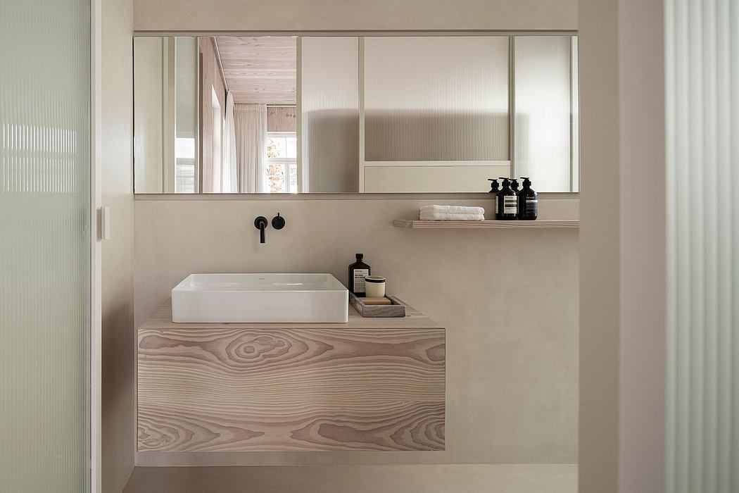 Minimalist bathroom design with floating vanity, rectangular vessel sink, and large wall mirror.