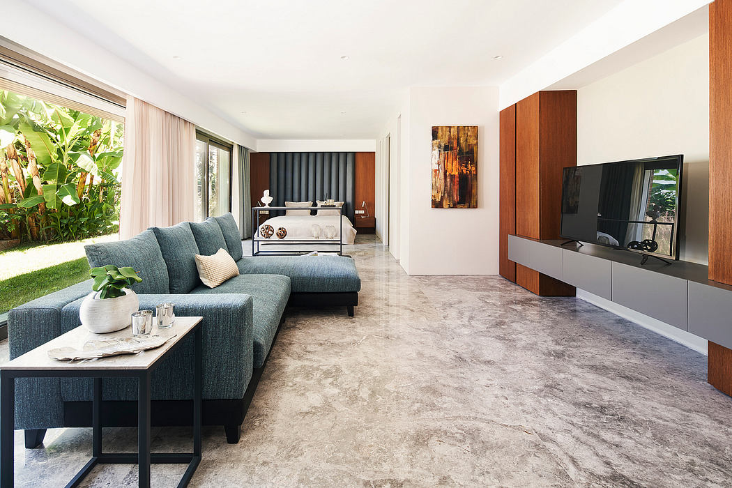 Spacious modern bedroom and living room with sleek furniture, decorative accents, and natural lighting.