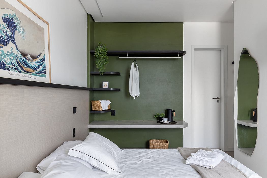 A cozy bedroom with a green accent wall, sleek shelving, and minimalist decor.
