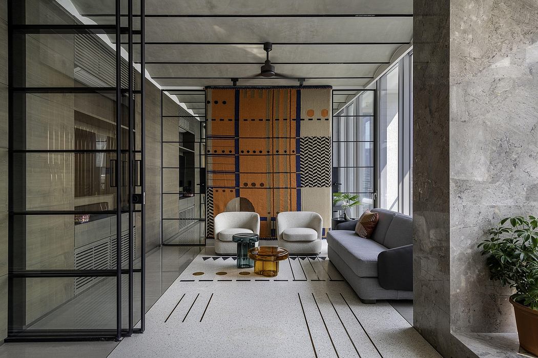 Minimalist interior with industrial-style ceiling, glass walls, and patterned textiles.