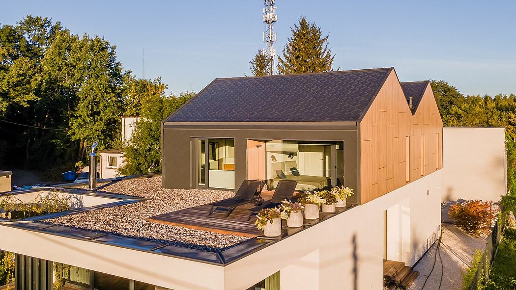 Modern yet cozy home with a pitched roof, deck, and sleek architectural design.