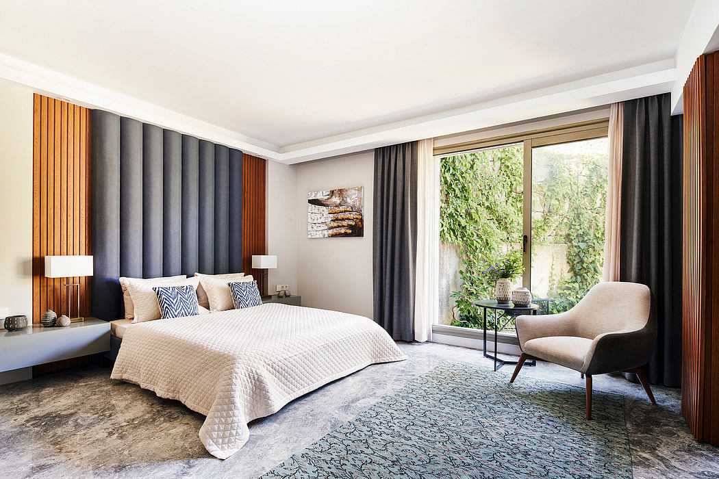 Spacious modern bedroom with wood paneled walls, large windows, and plush furnishings.