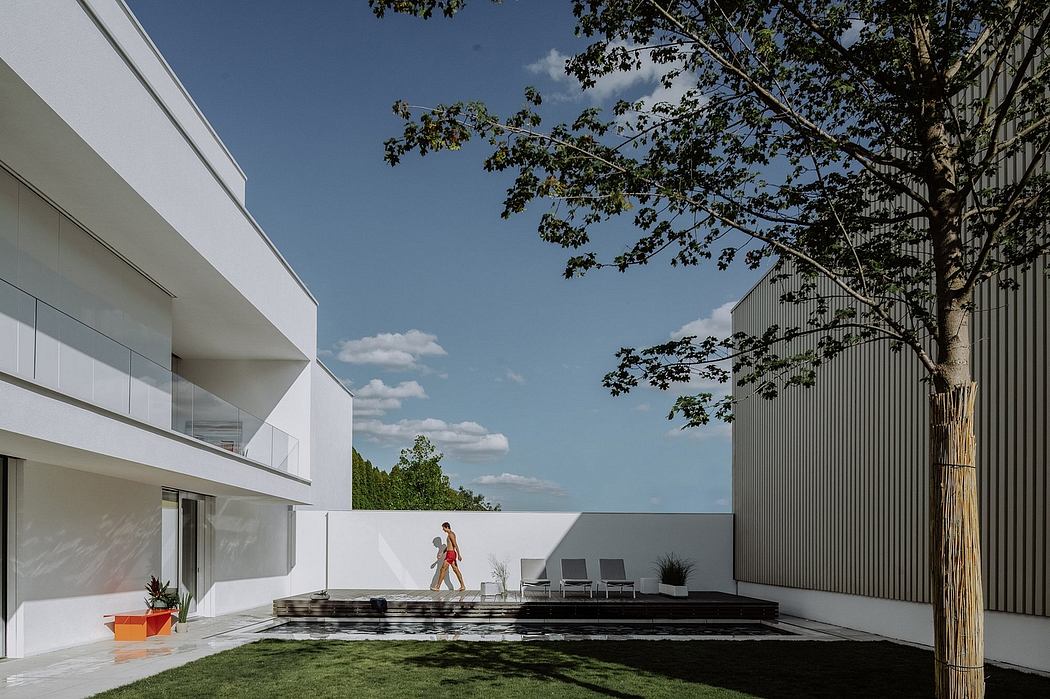 Modern architectural design with sleek lines, outdoor patio, and lush greenery.