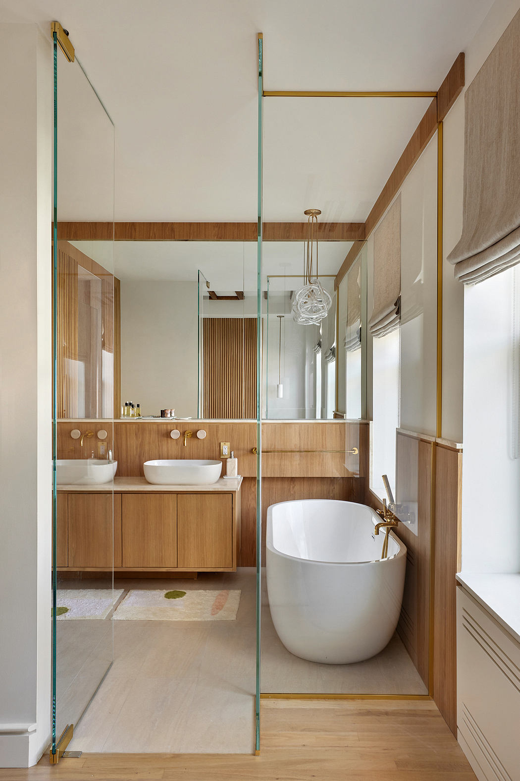 Sleek, modern bathroom with wooden vanity, freestanding tub, and glass enclosure.