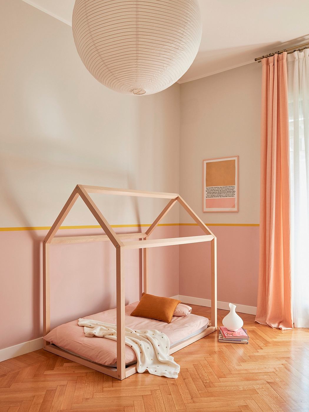 A cozy, minimalist room with a canopy bed, hardwood floors, and a large pendant light.