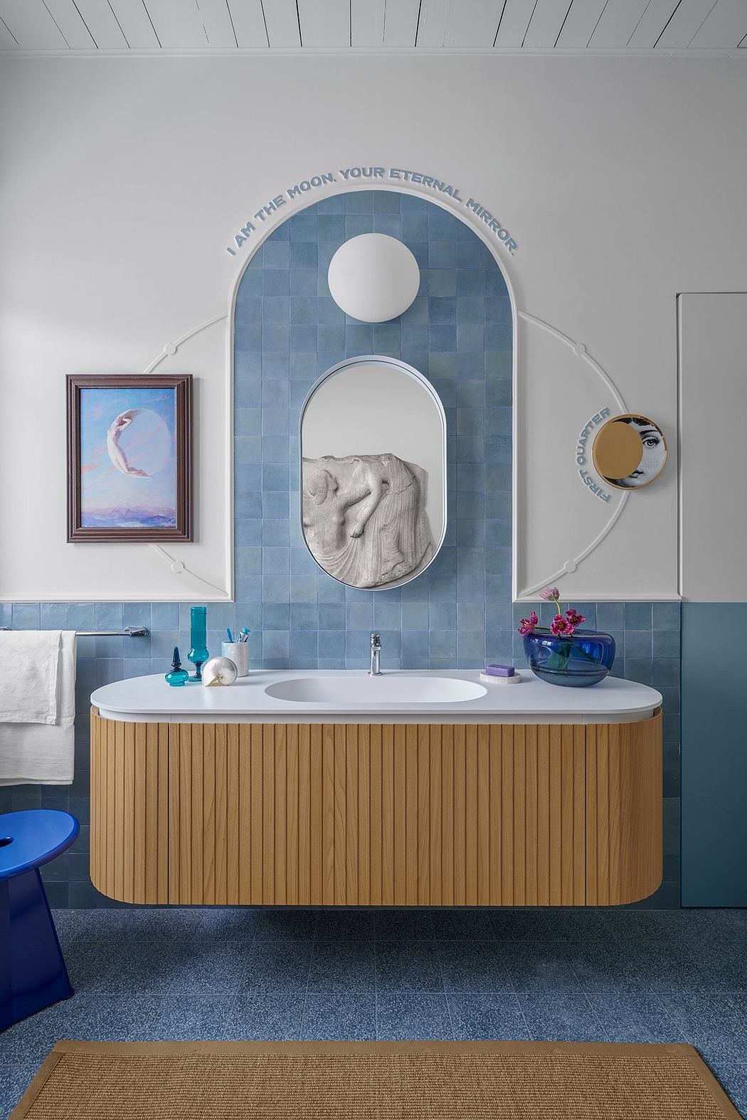 A modern bathroom featuring an arched tile backdrop, wooden vanity, and artistic decor.