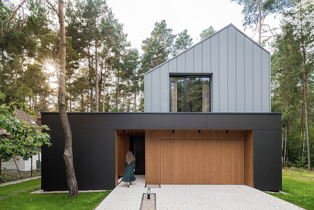 Striking modern home design with black siding, wood accents, and large windows.