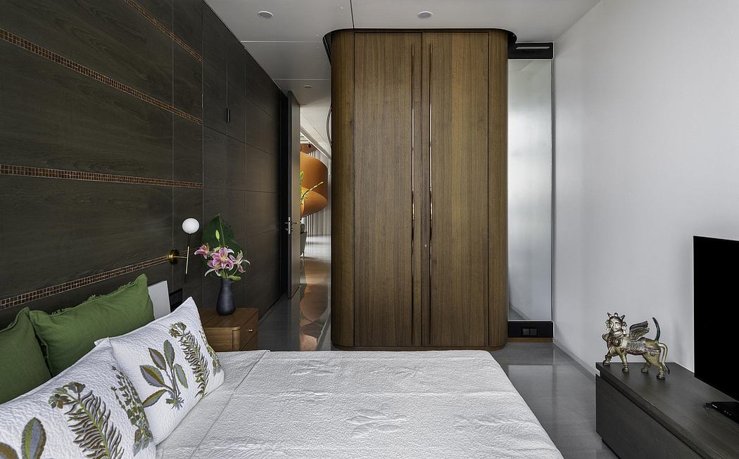 Elegant bedroom with dark tile walls, wooden closet, and decorative touches.