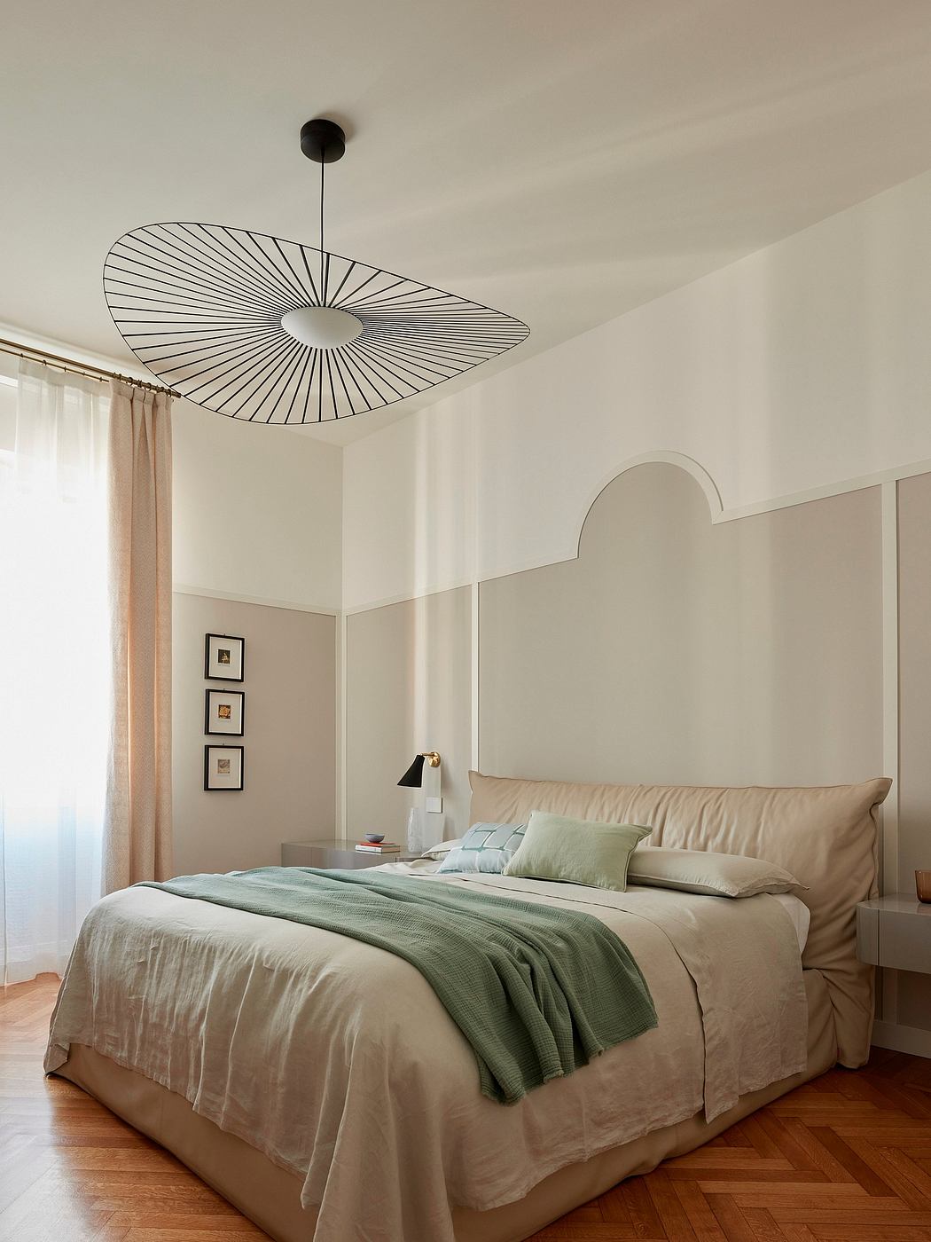 Minimalist bedroom with a striking pendant light and clean architectural details.