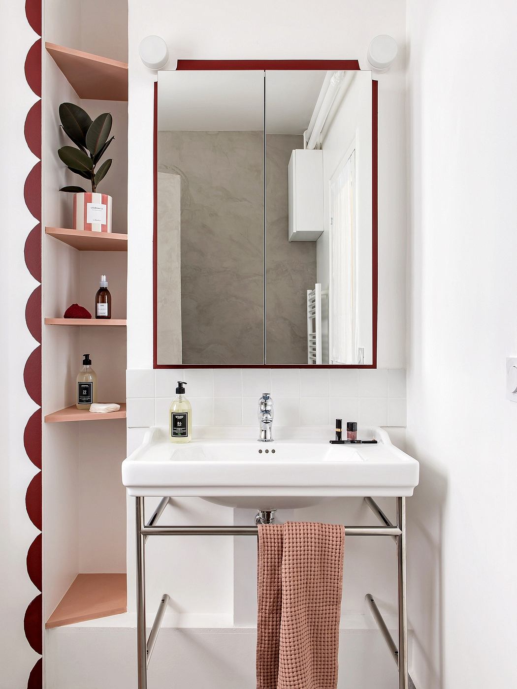 Minimalist bathroom design with concrete walls, floating vanity, and recessed shelving.
