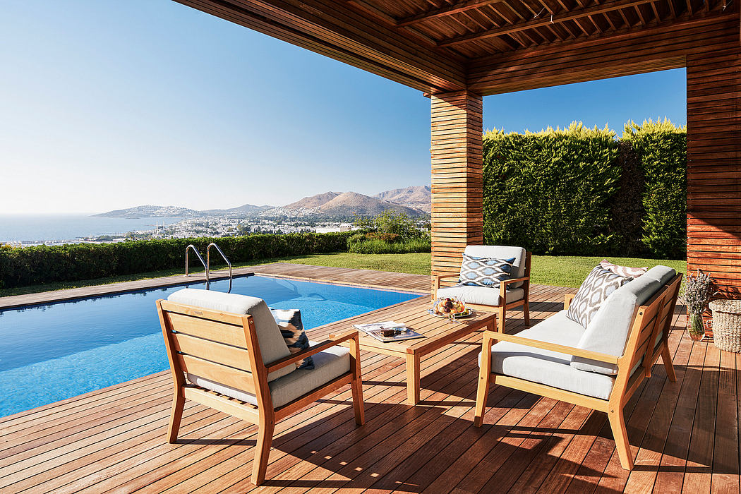 Wooden patio with pool and scenic mountain view, cozy outdoor seating area.