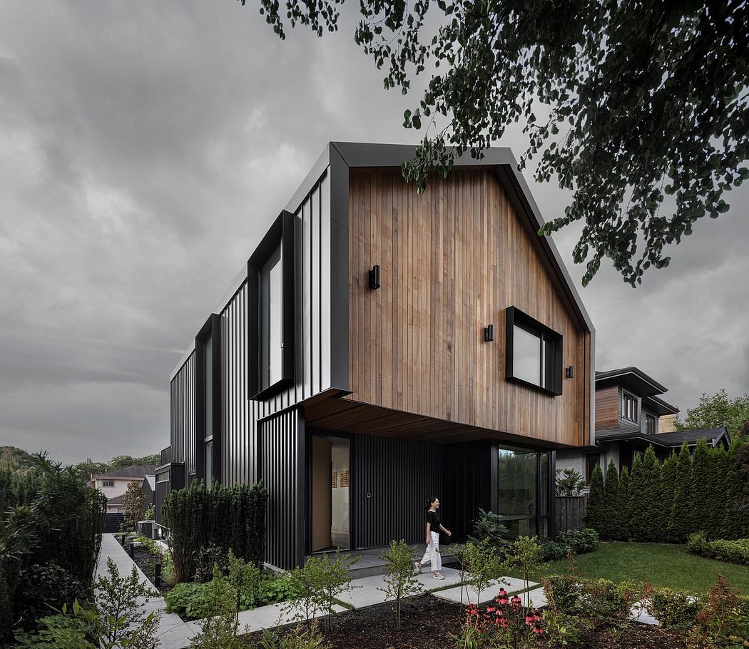 Striking modern home with an interplay of wood and steel siding, large windows, and a covered entryway.