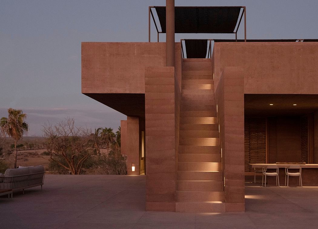 Striking modern desert architecture with angular concrete facade and recessed lighting.