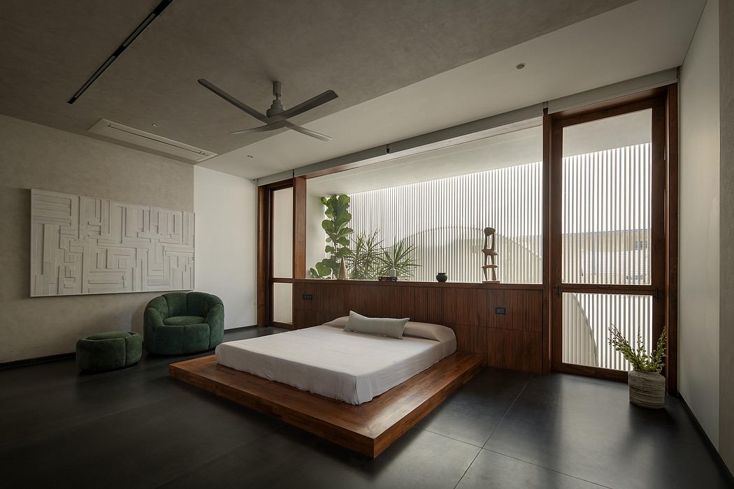 Minimalist bedroom with wooden platform bed, white walls, and modern art decor.
