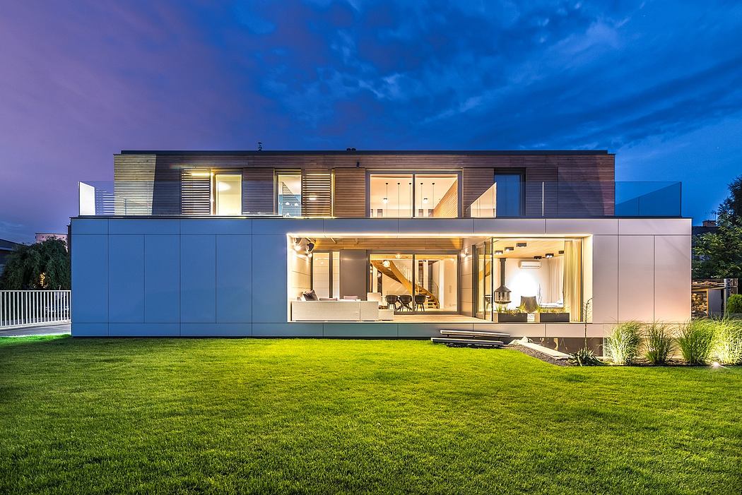 Modern modular home with glass walls, wooden accents, and well-lit interior spaces.
