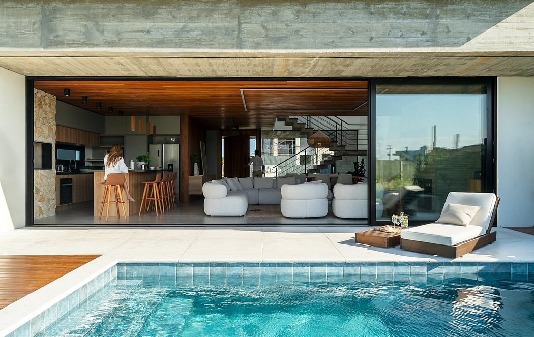 Modern home with open-concept living space, pool, and scenic outdoor views.