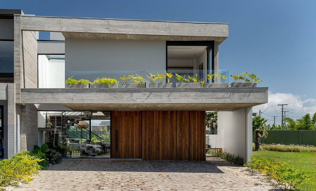 Contemporary, two-story residential building featuring wooden accents, balcony, and landscaped surroundings.