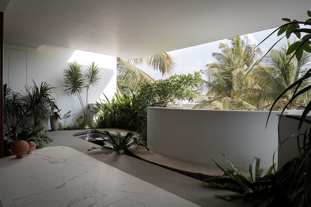 A modern, tropical-inspired bathroom with a freestanding bathtub, lush plants, and natural light.