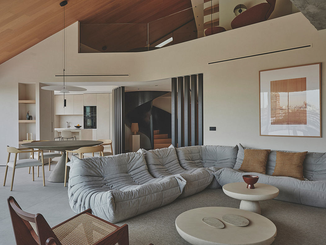 Spacious modern living room with vaulted ceiling, plush sectional, and sleek furnishings.