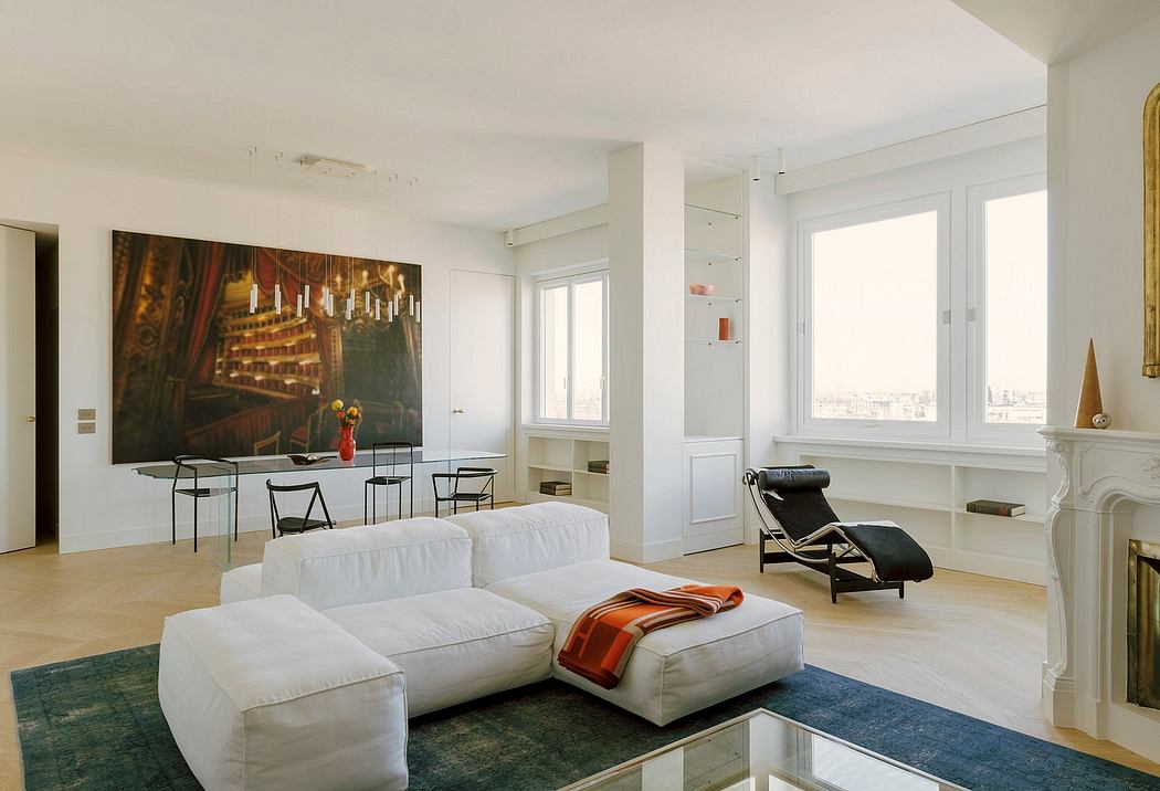 Spacious, minimalist living room with large artwork, modern furniture, and tall windows.