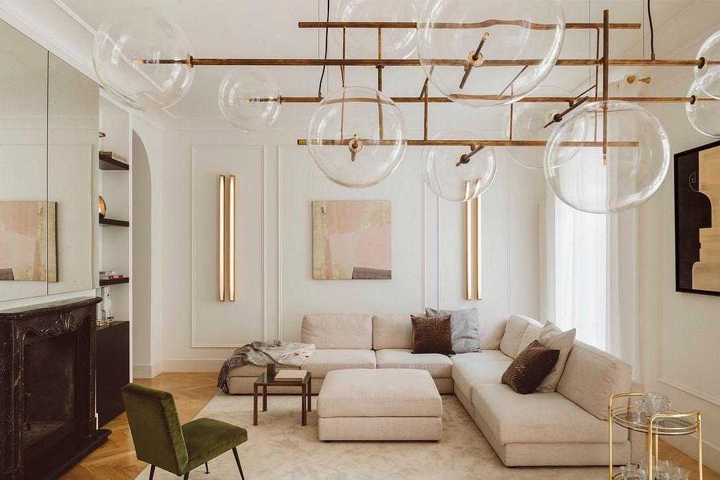 Plush upholstered sectional sofa with glass bubble chandeliers and wood-paneled walls.