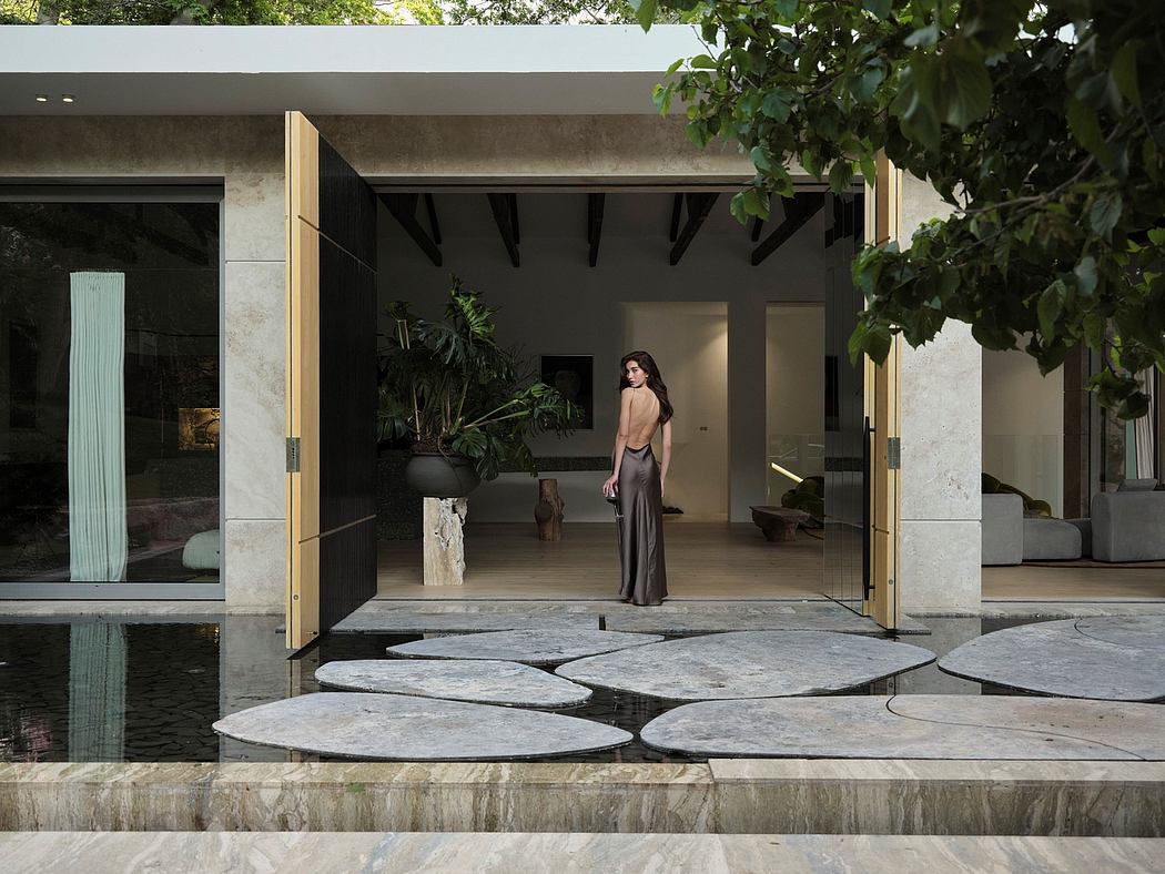 Stunning modern architecture with an elegant stone patio, greenery, and a minimalist interior.