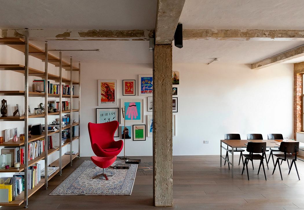 Stylish industrial-style loft with exposed brick, wooden shelves, and a vibrant red Egg chair.