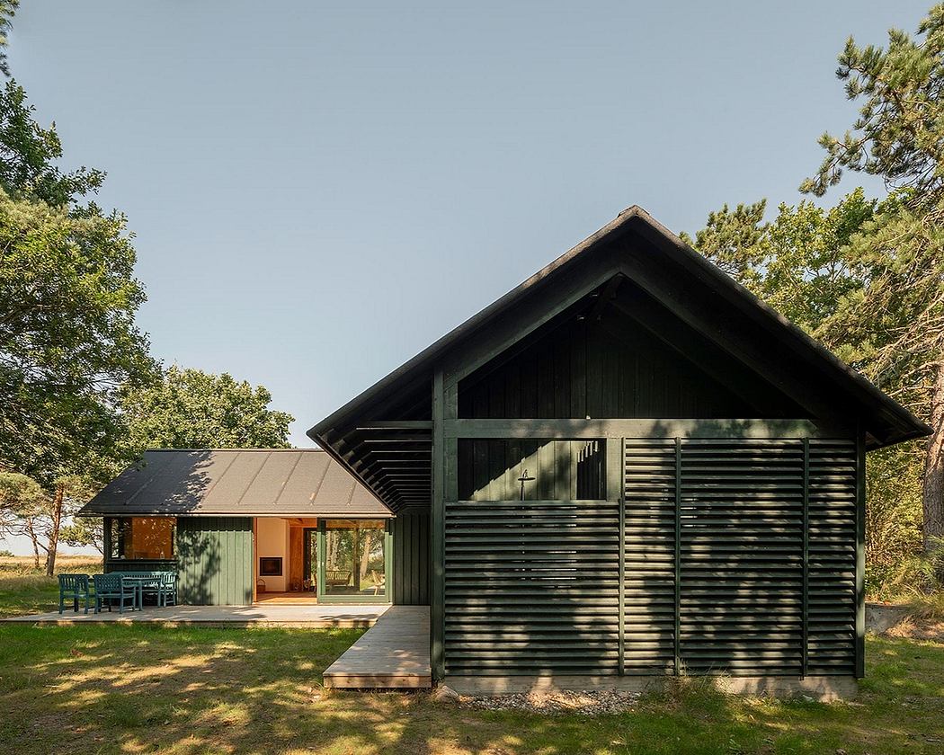 A modern, rustic cabin nestled in a wooded setting with a wraparound porch and clean lines.