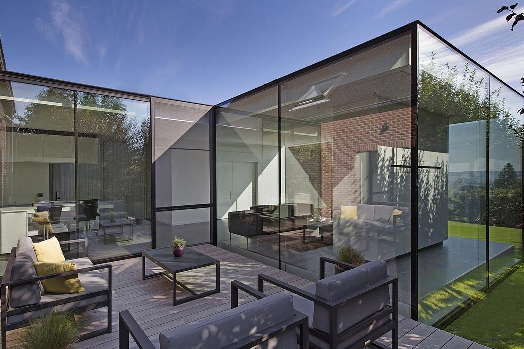 Modern glass pavilion with timber decking, landscaped garden, and minimalist furniture.
