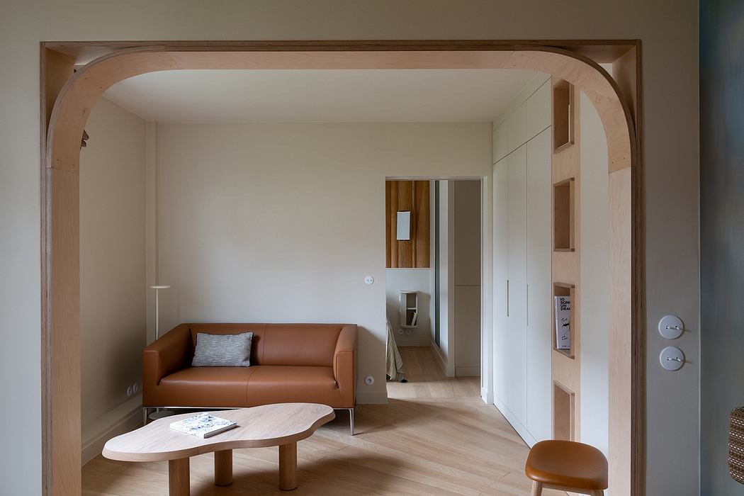 A warm, inviting living room with a modern leather sofa, wooden accents, and clean lines.