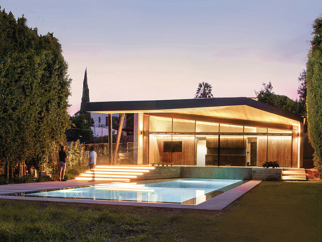 Contemporary glass-walled home with sleek wooden facade, illuminated pool, and lush greenery.
