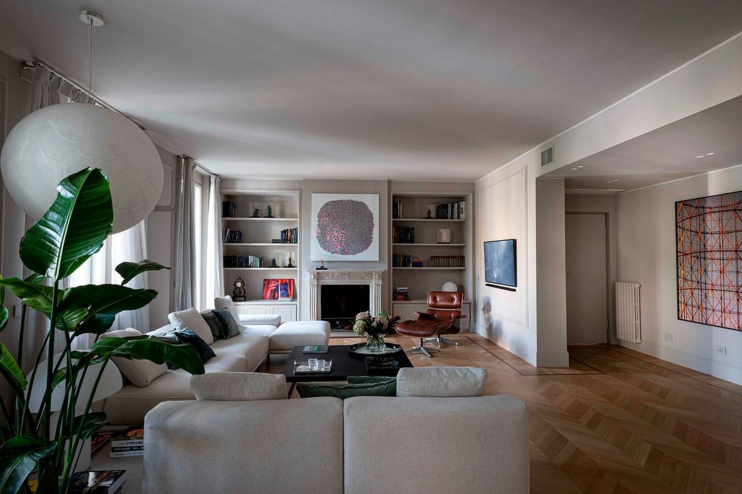 Elegant living room with neutral color scheme, modern furniture, and built-in bookshelves.